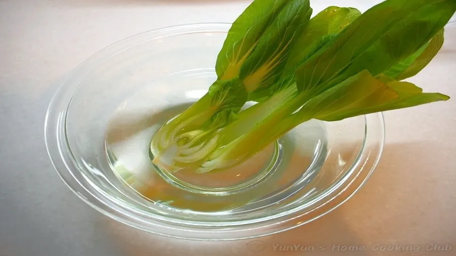 青梗菜の根元をボウルに入れた水で洗う。